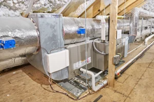 Modern furnace and duct system installed in attic space showing proper airflow and insulation