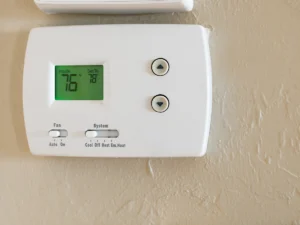 Digital thermostat showing cool or heat mode switch for seasonal comfort in a home