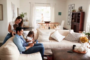 Family relaxing in a bright living room with clean indoor air from whole-home air purifier and humidifier systems