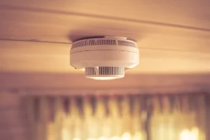 Carbon monoxide detector on a ceiling inside a home, used to detect CO levels when a carbon monoxide detector is beeping
