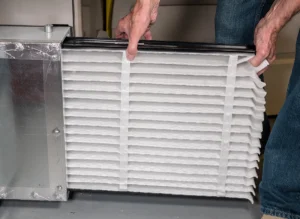 Technician showing how to change furnace filter for better airflow and indoor air quality