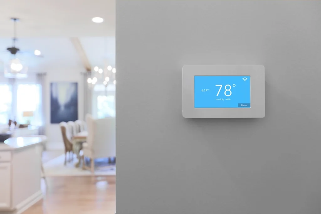 Smart thermostat displaying indoor humidity level, helping homeowners understand when to increase humidity in the house during winter.